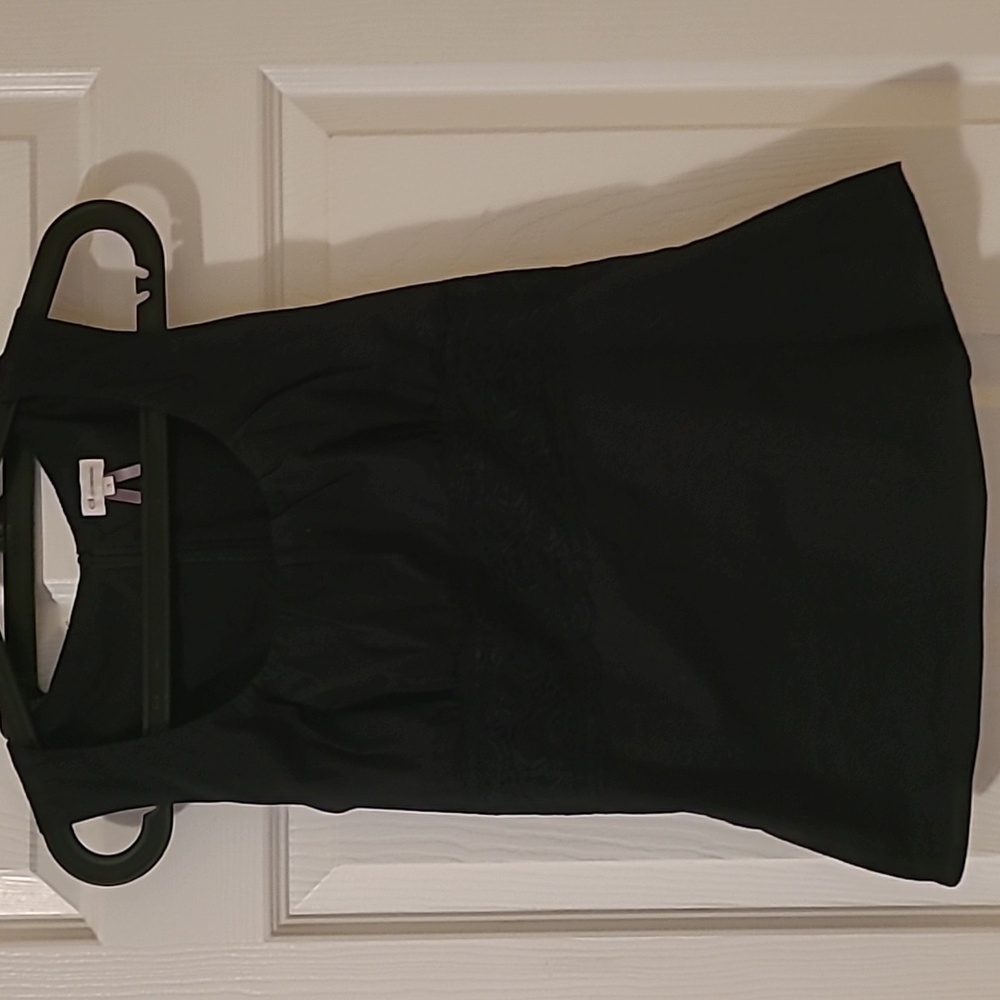 Black sleeveless top with lace detail and beautiful neck seams.
